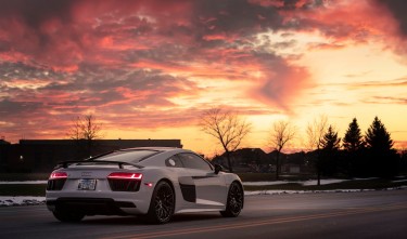 A WHITE SPORTS CAR ON THE ROAD  AUDI