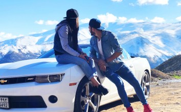 COUPLE NEAR WHITE CHEVROLET COUPE