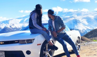 COUPLE NEAR WHITE CHEVROLET COUPE